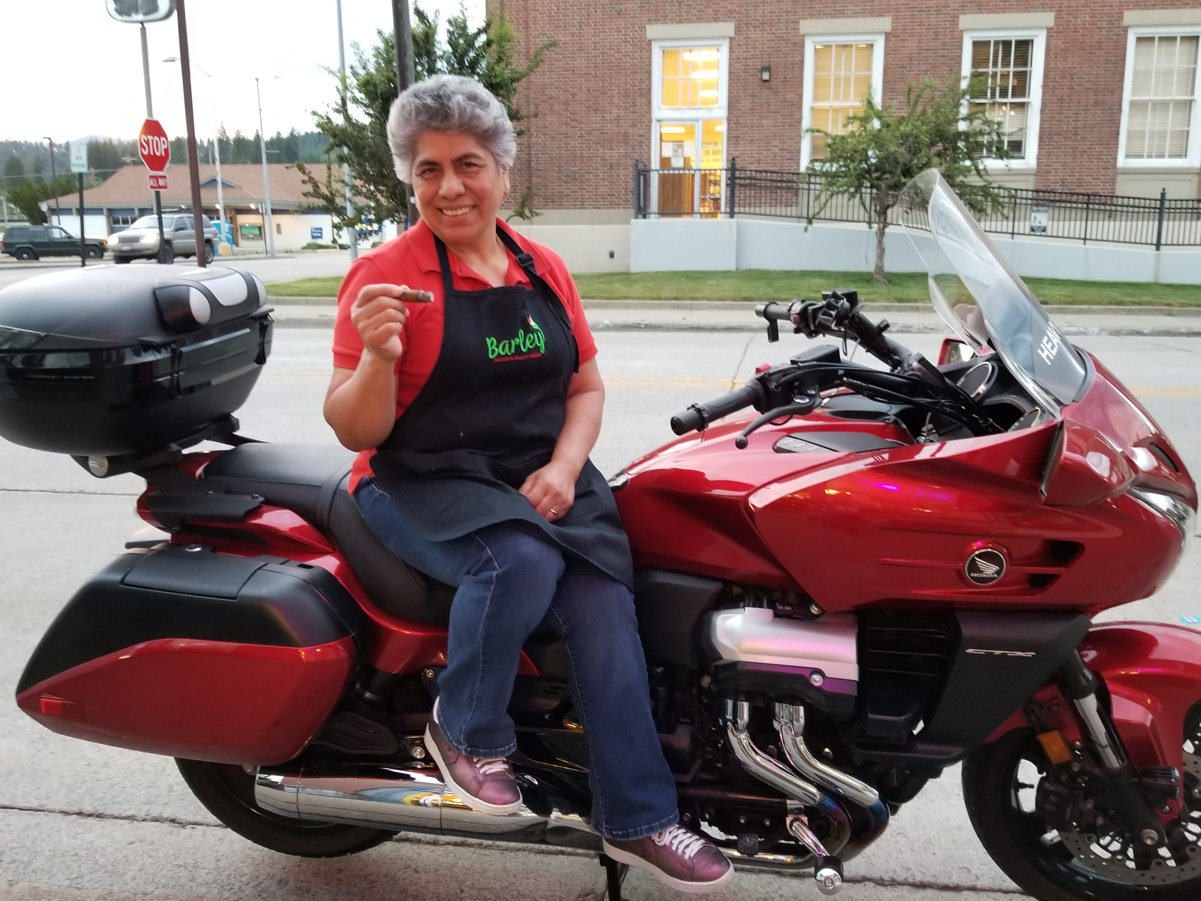 Elva on a motorcycle with a cigar